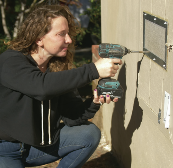 woman installing vent